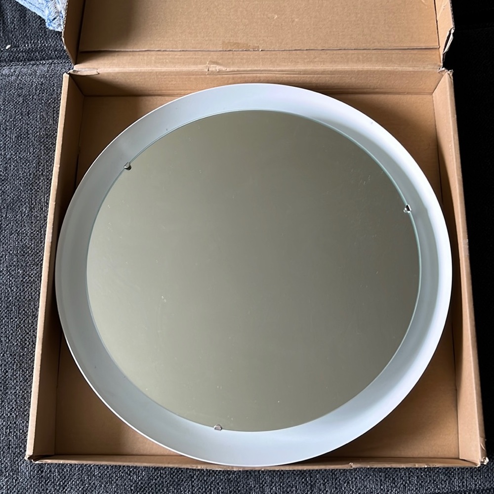 Vanity mirror, lights up and hangs on wall. Has never been used bought from ikea